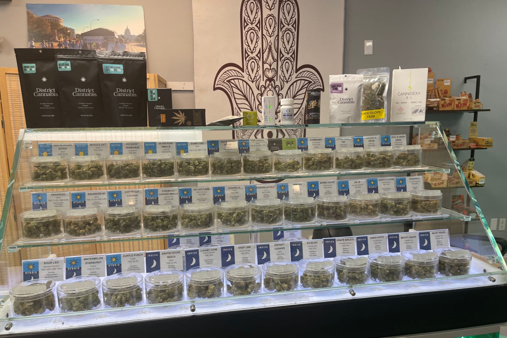 Cannabis flower displayed in jars at a dispensary counter